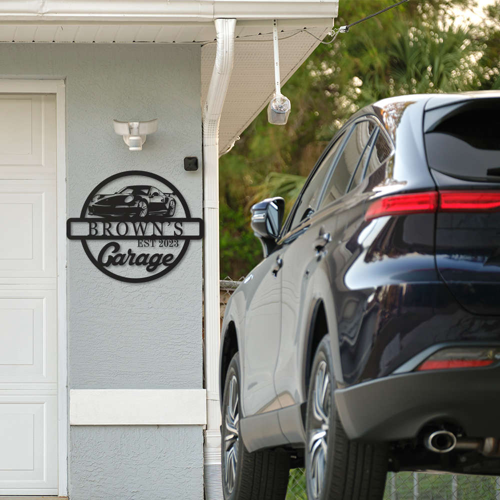 Personalized metal garage sign featuring a sports car silhouette and custom name with "Garage" and established year, laser-cut from durable powder-coated steel for indoor or outdoor use.