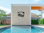 Customizable black metal sign with a tropical design, featuring palm trees, a beach umbrella, lounge chair, beach ball, and cocktails, with "Welcome to The Johnson's Pool & Bar" text.