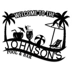 Customizable black metal sign with a tropical design, featuring palm trees, a beach umbrella, lounge chair, beach ball, and cocktails, with "Welcome to The Johnson's Pool & Bar" text.