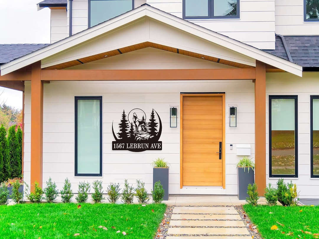 Custom laser-cut metal sign with howling wolf, pine forest, and personalized address  in durable powder-coated steel for outdoor use.