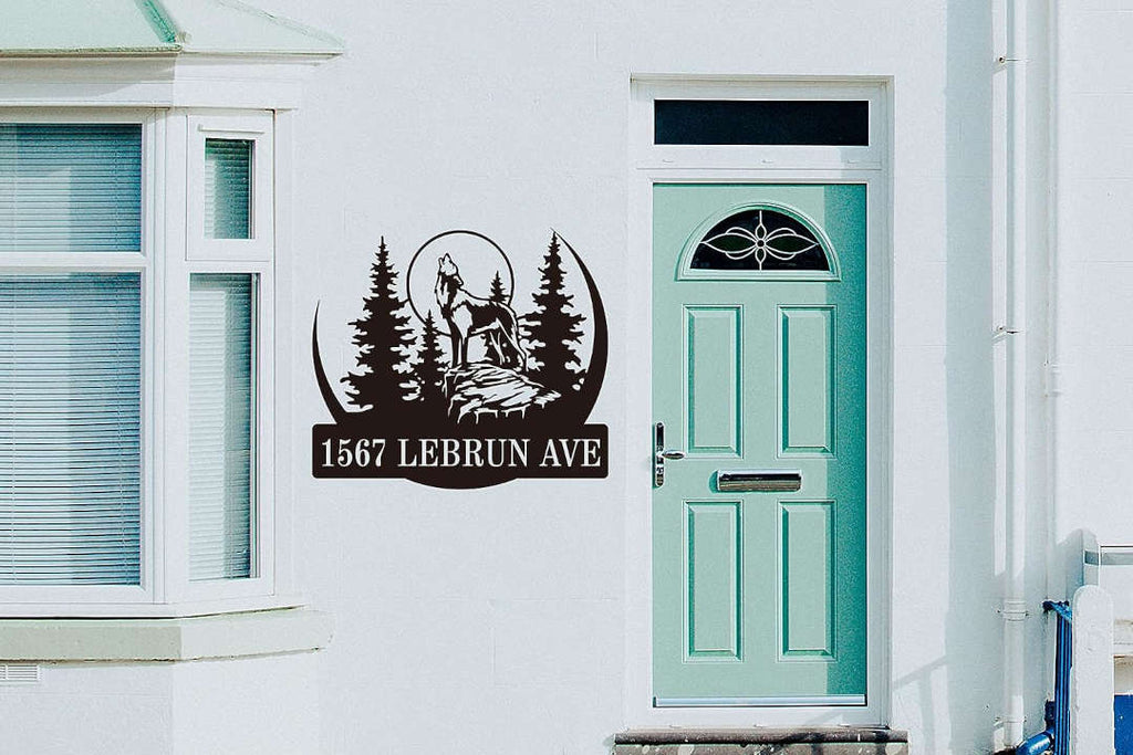 Custom laser-cut metal sign with howling wolf, pine forest, and personalized address  in durable powder-coated steel for outdoor use.