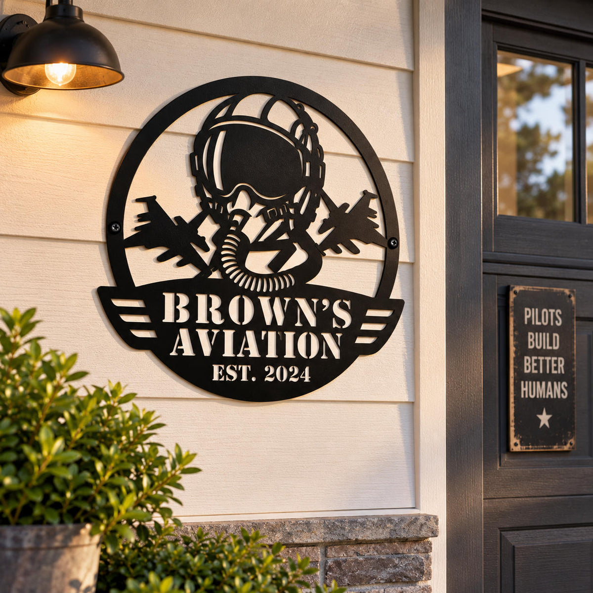 Custom Brown’s Aviation metal sign mounted on a stone wall beside a welcoming front porch entrance.