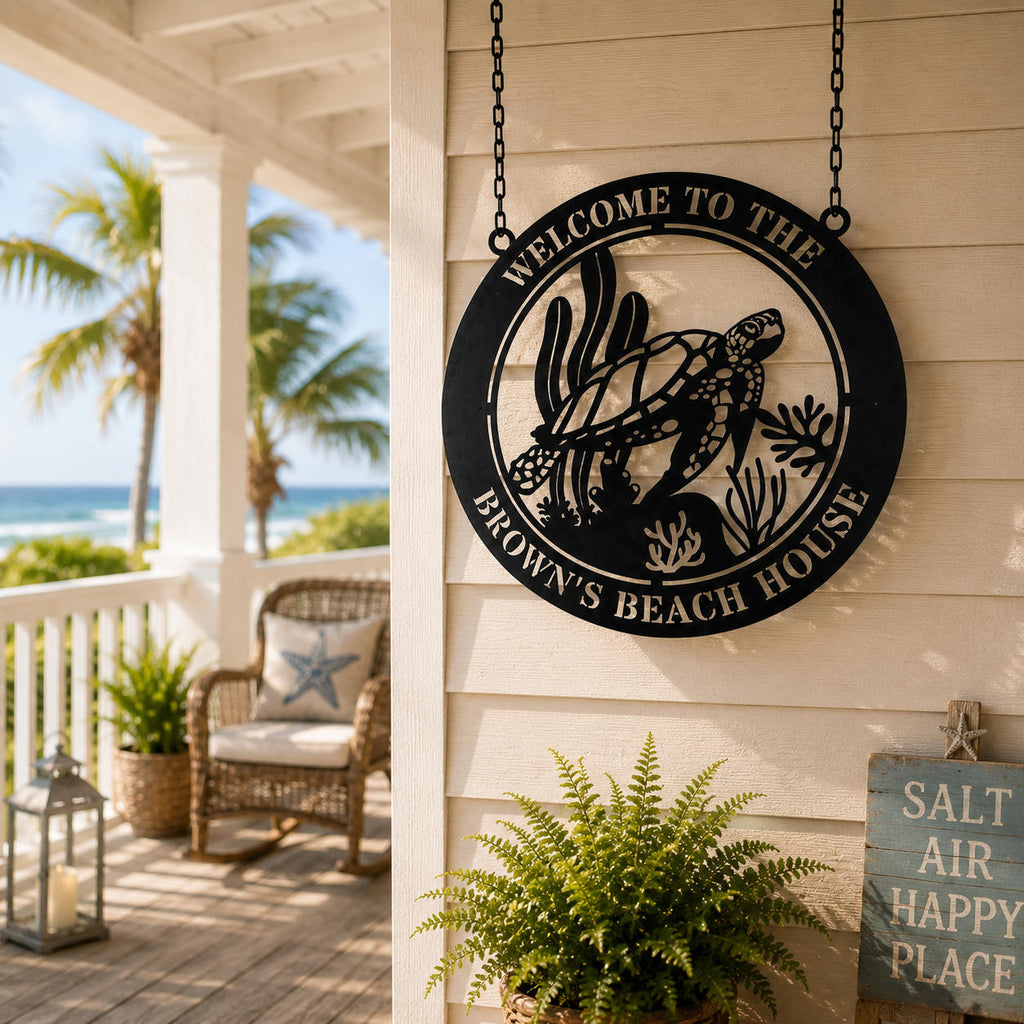 Personalized sea turtle beach house metal sign hanging by two top holes on a coastal porch.