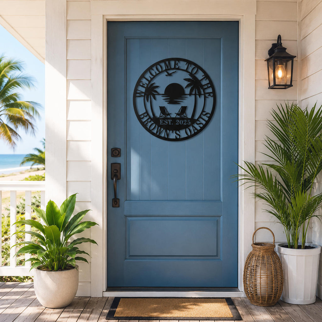 Custom tropical beach metal welcome sign installed on a coastal home's front door with palm trees and sunset design.