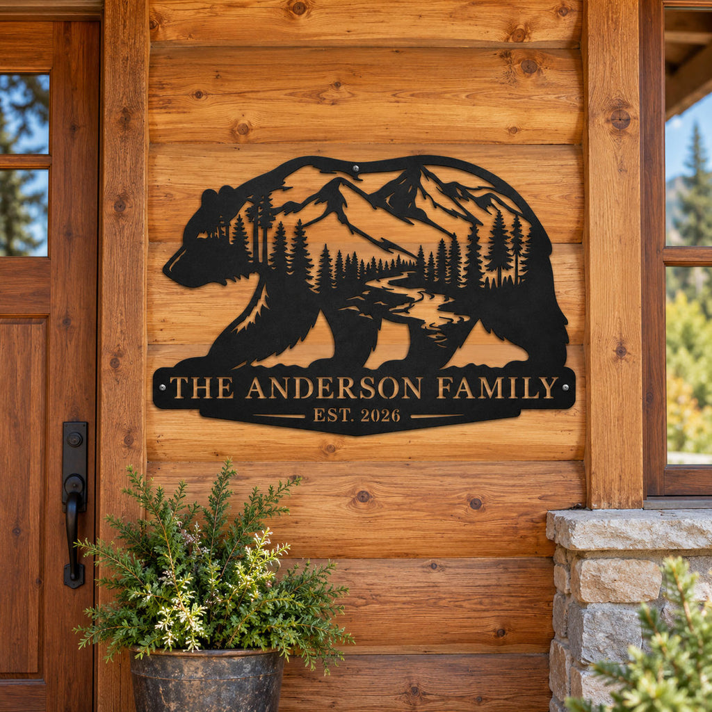 Personalized bear mountain metal sign with Anderson family name mounted on a rustic log cabin exterior wall.