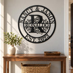 Personalized family monogram sign above a walnut entryway console with a ceramic vase, key tray, and woven basket.