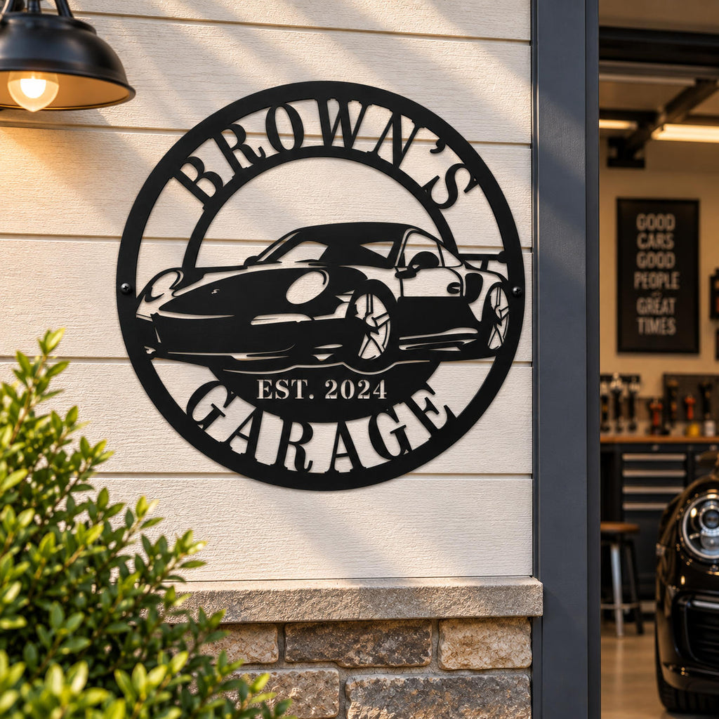 Personalized Brown's Garage metal sign displayed on an outdoor garage wall with a warm industrial light.