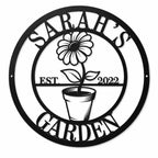 Personalized Sarah's Garden round black metal sign with flower pot design and established year.