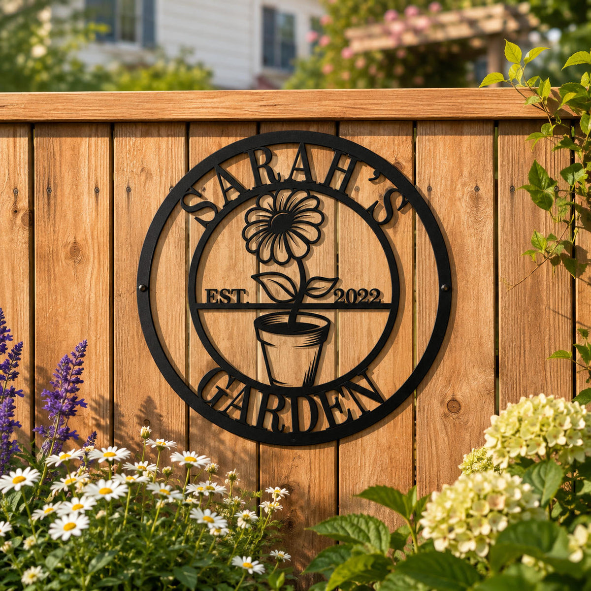 Personalized round garden metal sign mounted on a wooden fence in a charming backyard garden.
