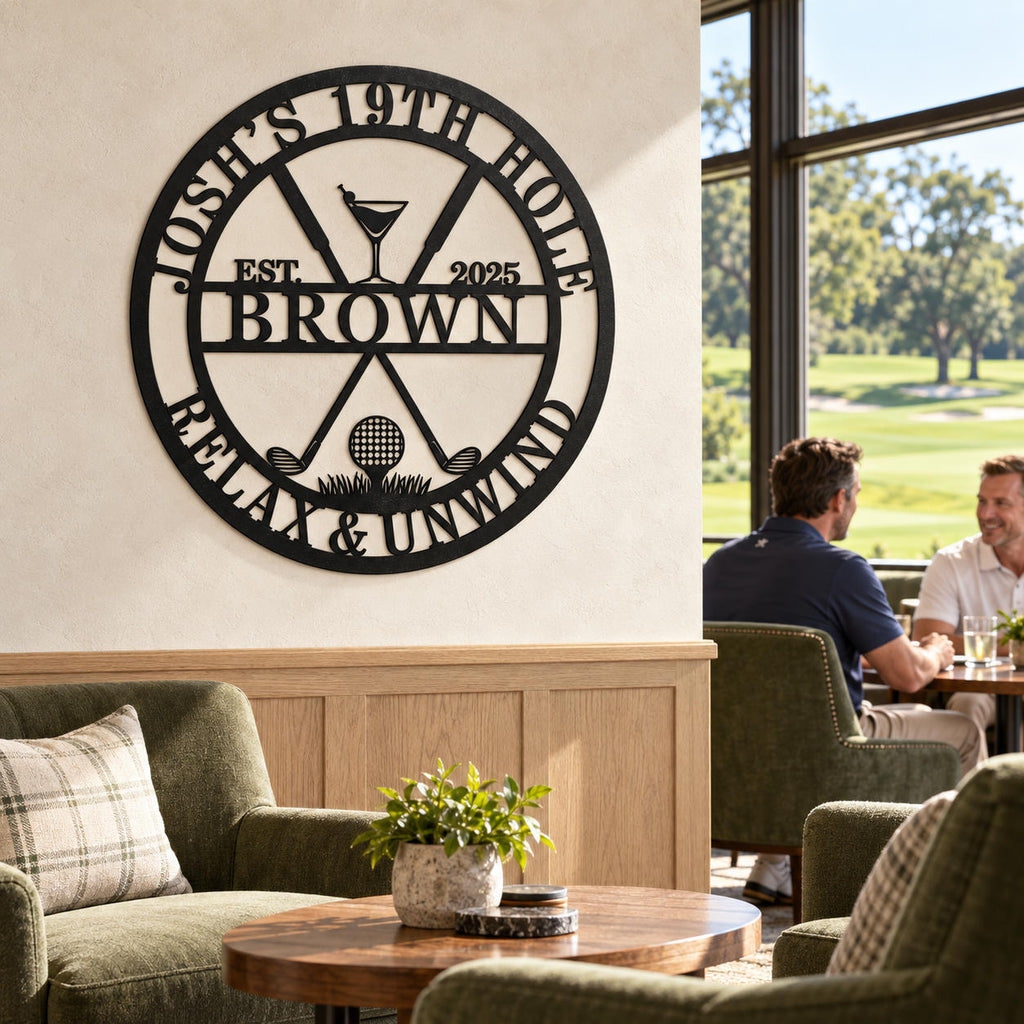Personalized black metal golf bar sign in a bright clubhouse lounge, with olive armchairs and two golfers chatting beside windows overlooking the course.