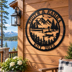 Personalized lake house metal sign displayed on a rustic wood cabin exterior overlooking a mountain lake.