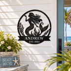 Personalized mermaid metal family name sign displayed on a coastal home porch wall.