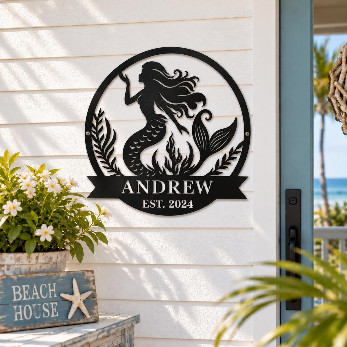 Personalized mermaid metal family name sign displayed on a coastal home porch wall.