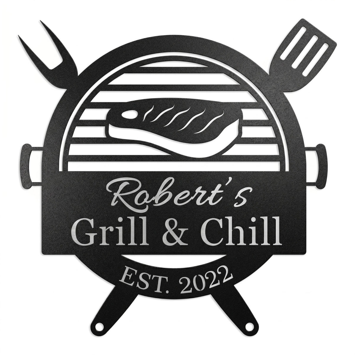 Customized metal BBQ grill name sign featuring a laser-cut steak and grill design, personalized with "Robert's Grill & Chill" and "Est. 2022" on a white brick wall.