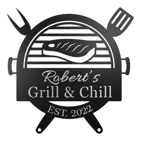 Customized metal BBQ grill name sign featuring a laser-cut steak and grill design, personalized with "Robert's Grill & Chill" and "Est. 2022" on a white brick wall.