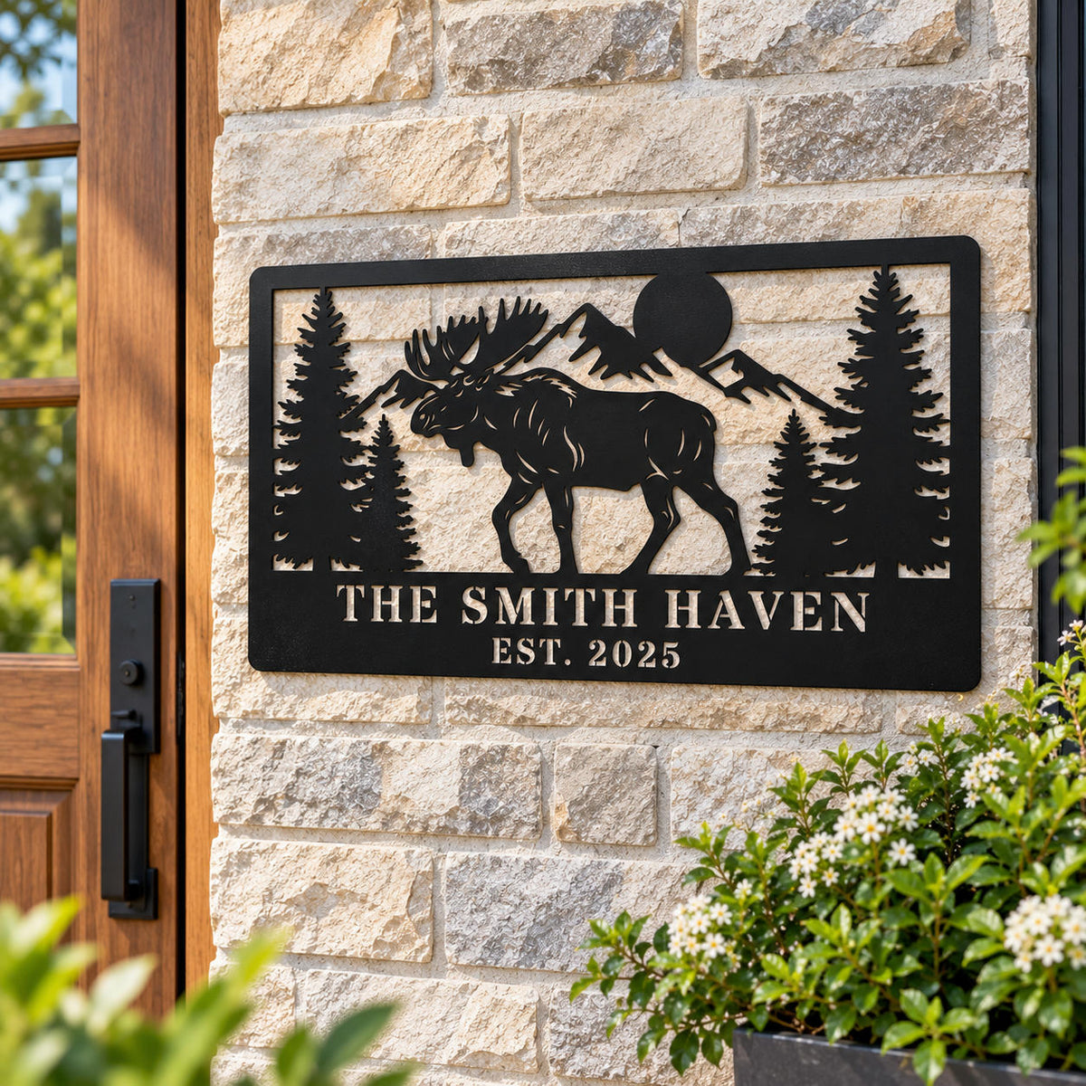 Personalized black metal moose sign displayed on a stone wall beside a rustic wooden entry door.