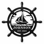 Personalized ship wheel metal sign with sailboat design and custom text displayed on a clean white background.