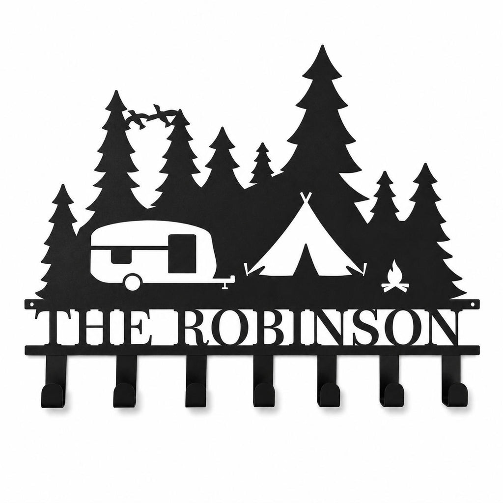 Personalized RV camping metal key holder with custom family name on a clean white background.