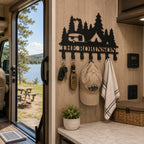 Personalized RV key rack mounted inside a camper with keys, a cap, and a light hand towel.