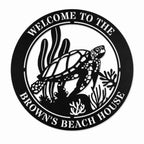 Personalized sea turtle beach house metal sign with custom family name on a white background.