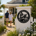 Personalized sea turtle metal sign decorating the garden entrance of a coastal beach cottage.