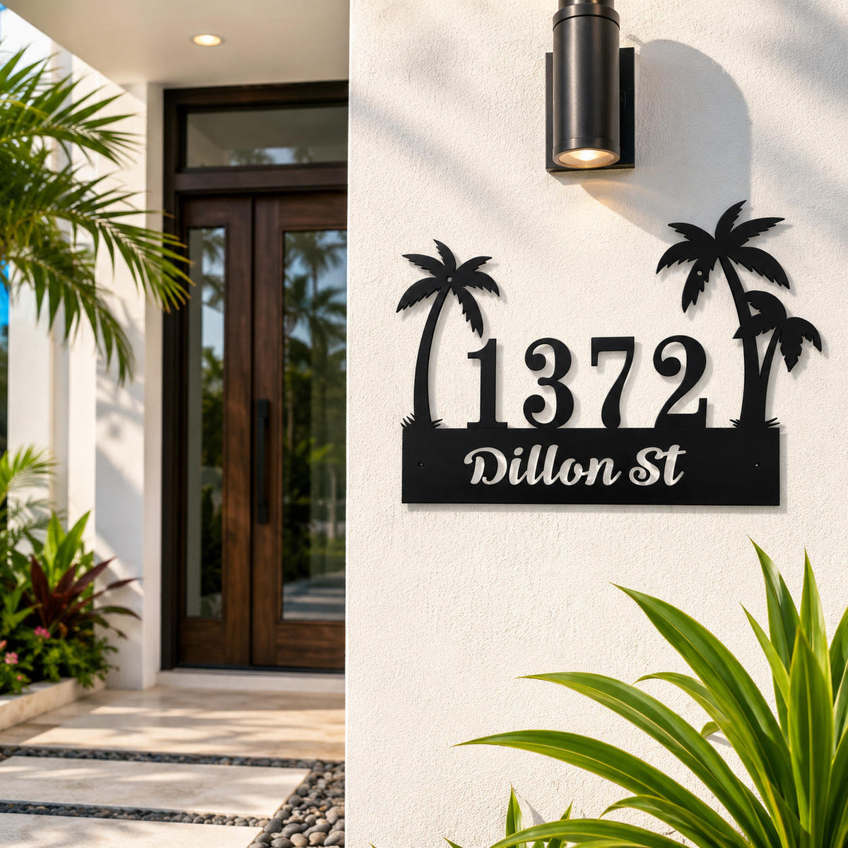 Personalized tropical palm tree metal address sign mounted on a modern Florida home's exterior wall with custom house number and street name.