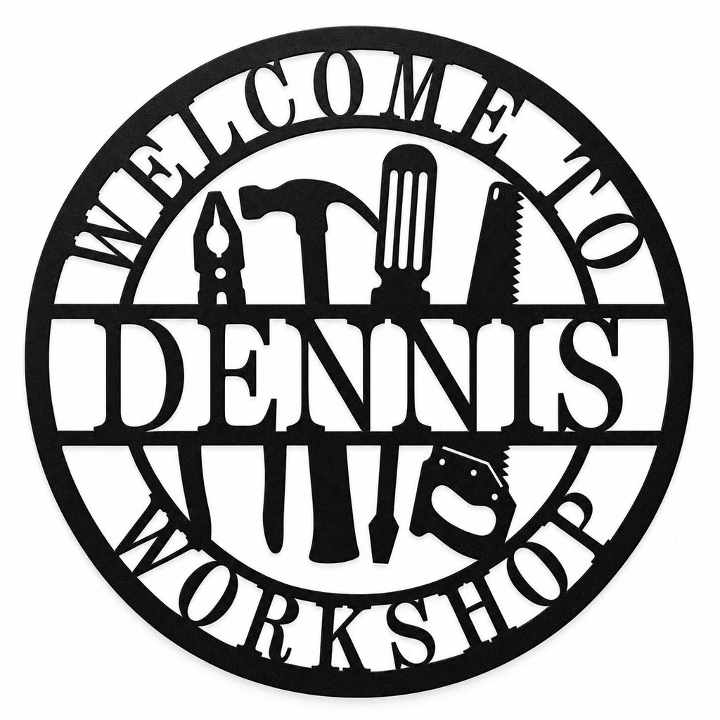 Round black metal workshop sign with tool silhouettes and WELCOME TO DENNIS WORKSHOP text on a white background.