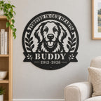 Personalized golden retriever memorial metal sign on a warm gray living room wall beside an oak bookshelf and cream armchair.