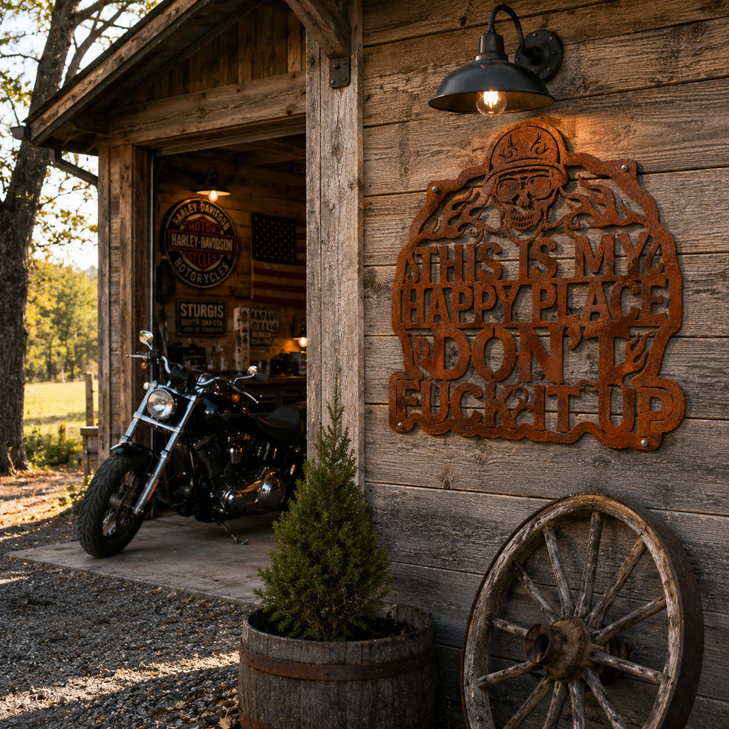 Rusted corten steel biker skull sign mounted on a motorcycle garage wall with rustic outdoor decor