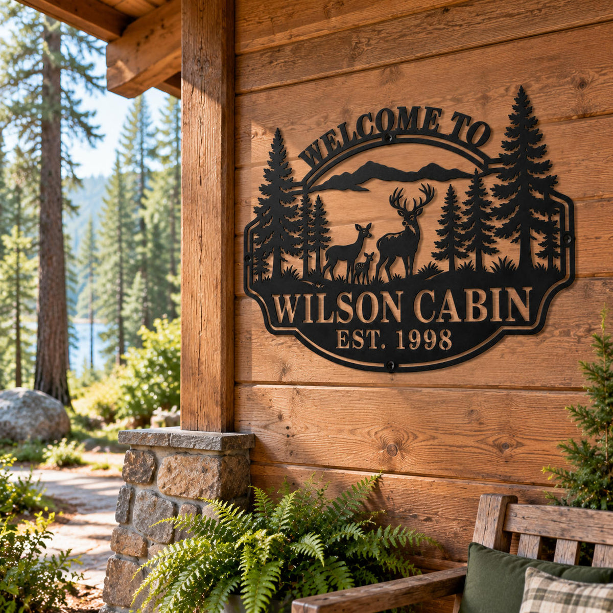 Black deer family metal sign mounted on a rustic woodland cabin wall surrounded by pine trees