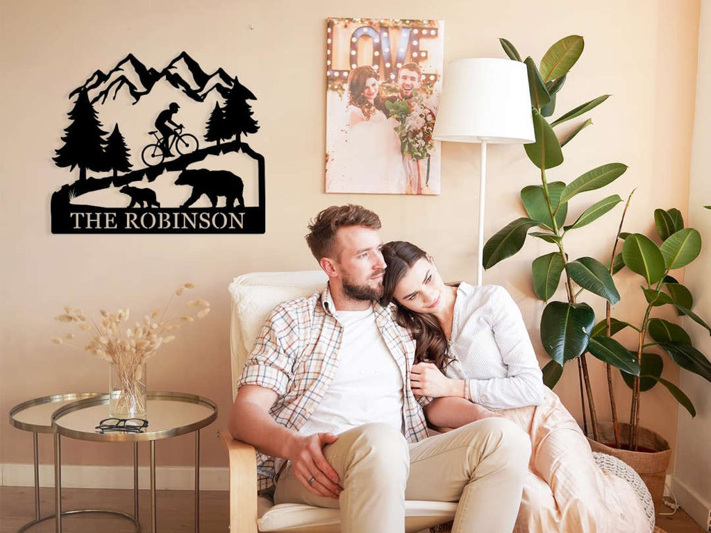 Custom bicycle metal sign with mountain and bear design, personalized family name cycling wall art, laser cut steel décor for rustic home or outdoor cabin.