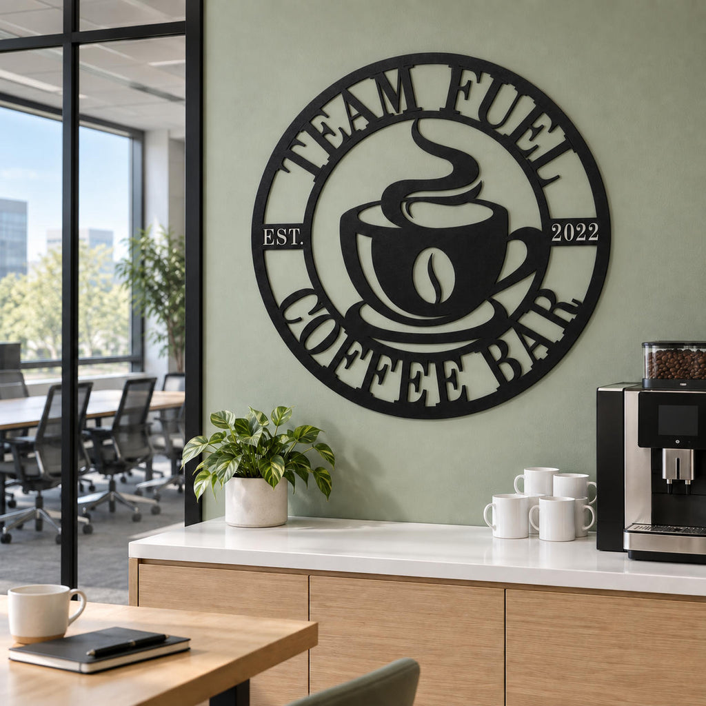 Custom Team Fuel coffee bar metal sign on a sage green wall beside an office coffee machine and a glass-enclosed meeting room.