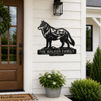 Custom wolf family name metal sign displayed beside a modern farmhouse entryway.